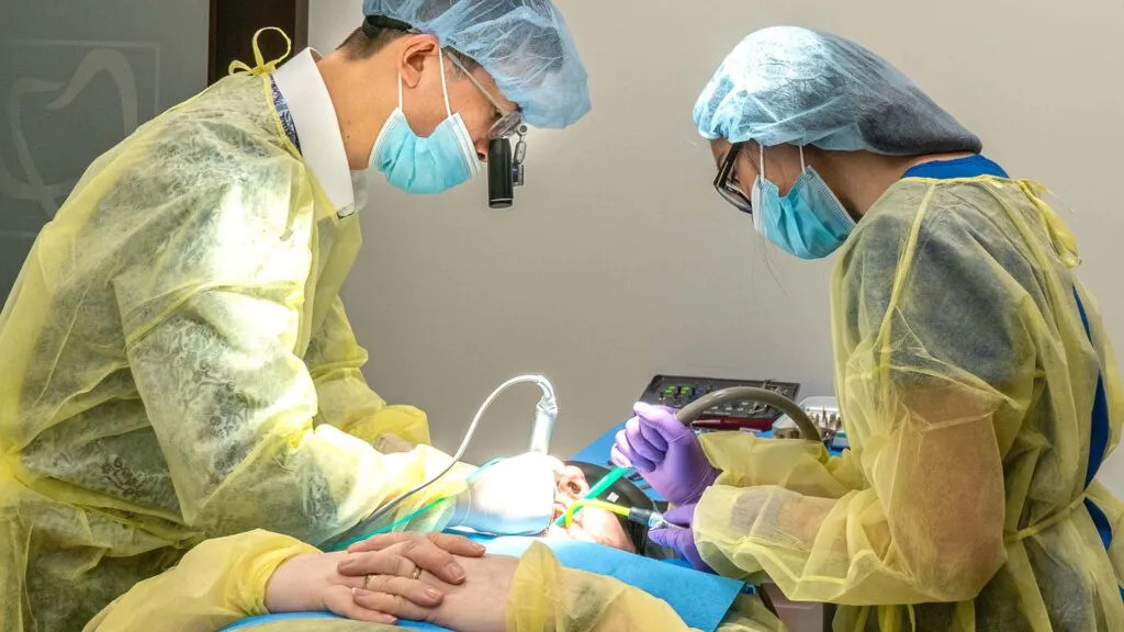 Emergency dental clinic staff operating in yellow uniforms