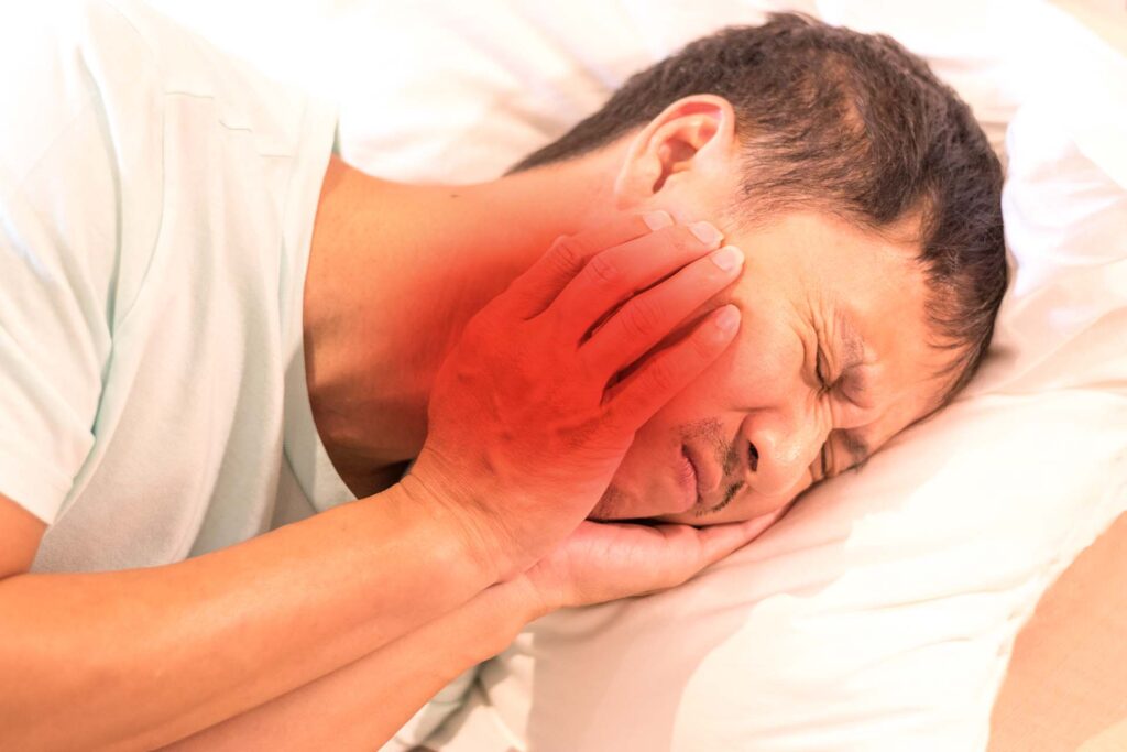 Man lying on side with toothache