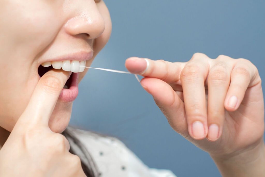 1920 smiling women use dental floss white healthy teeth 2